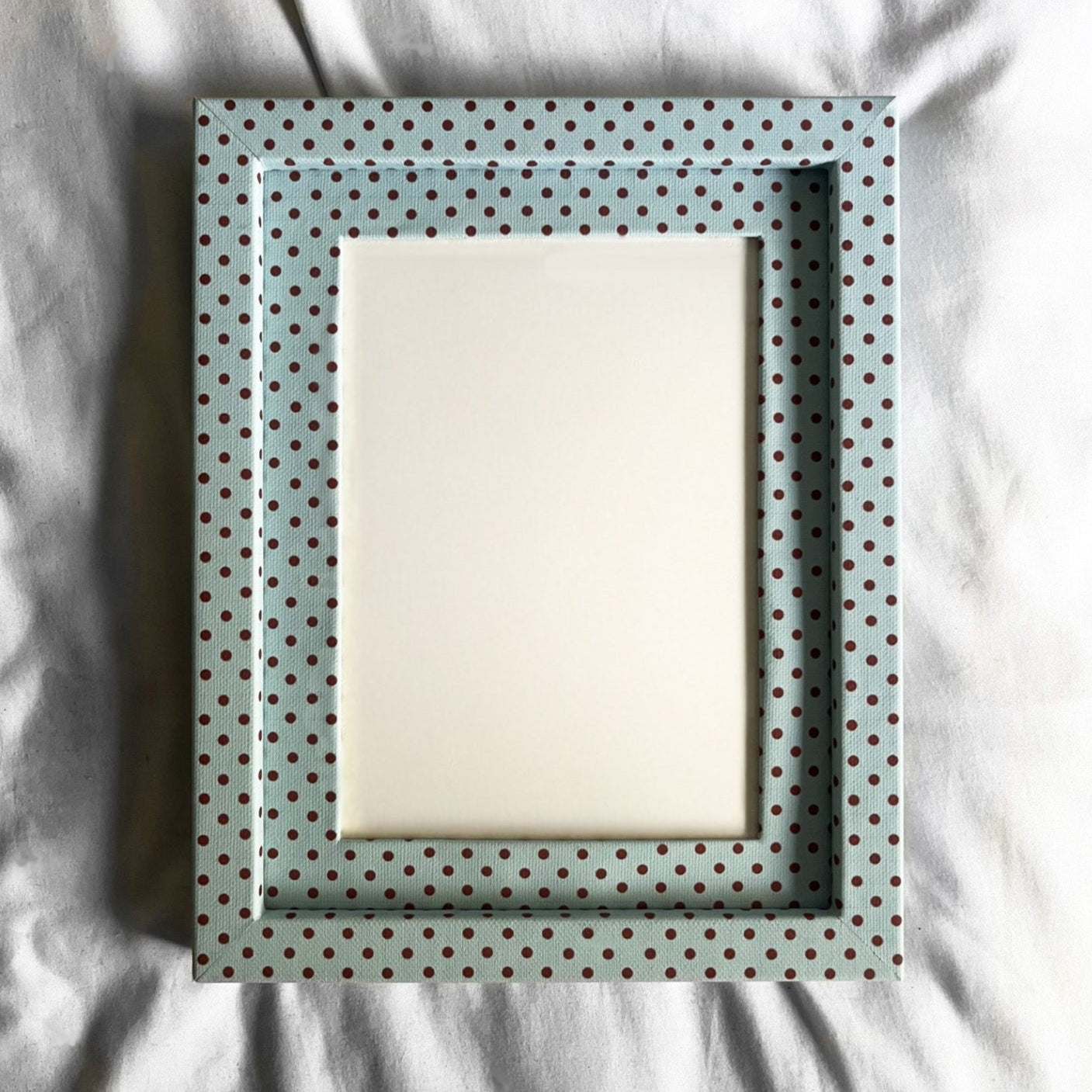 Polka dot picture frame on a textured surface