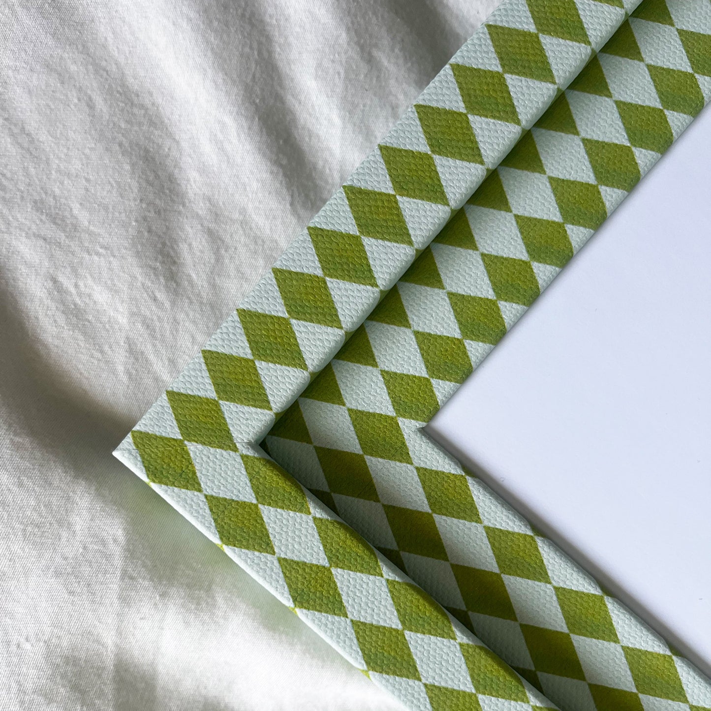 Green and blue fabric frame detail, showing texture and colour