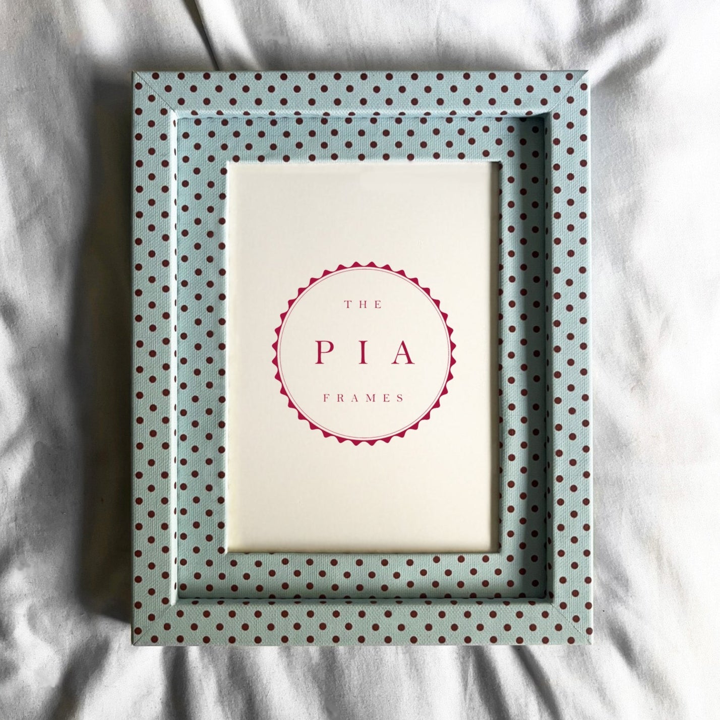 Polka dot picture frame white fabric background