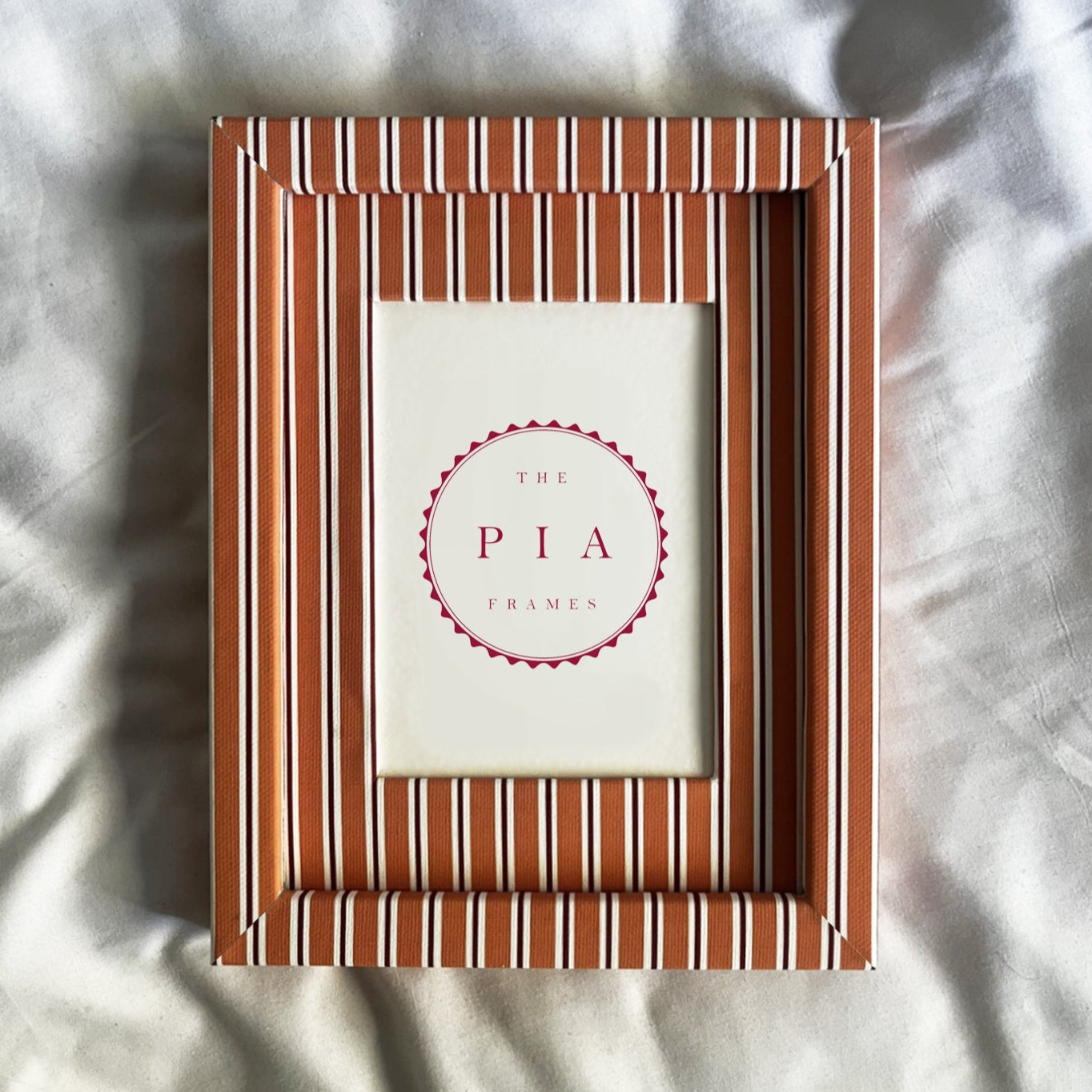 orange striped photo frame on a textured white background
