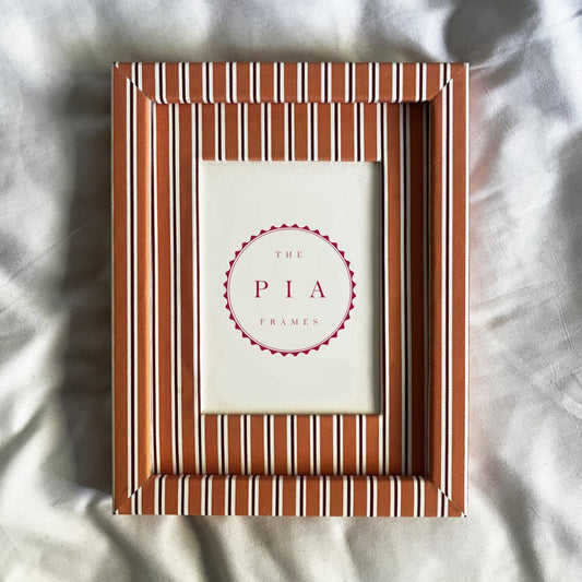 orange striped photo frame on a textured white background