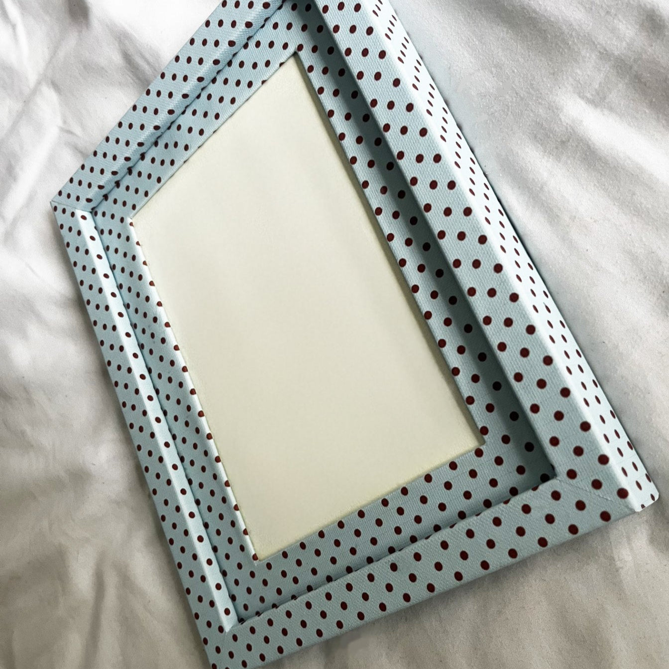 polka dot picture frames on a light fabric background