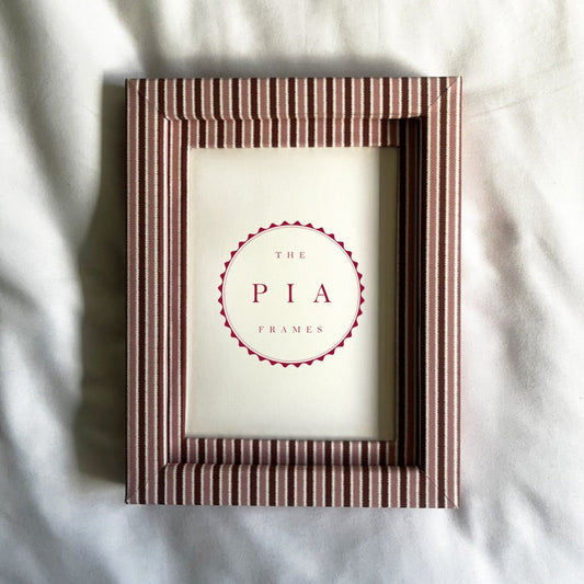 Striped photo frame on light background