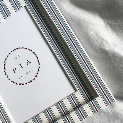 close up view of hand made blue and red striped cotton picture frame