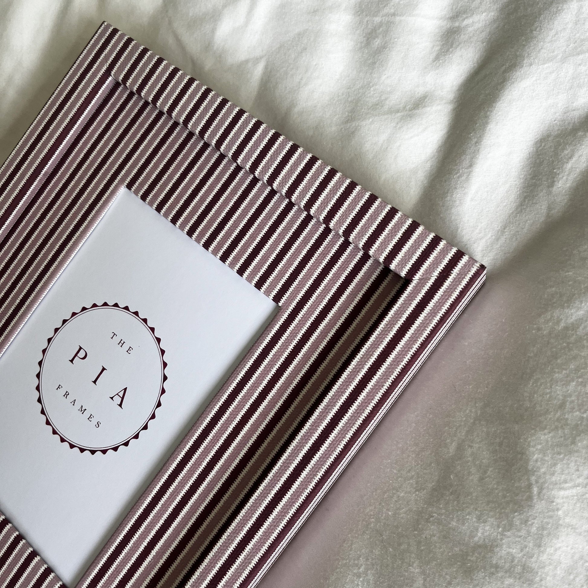 Handmade blush and burgundy zigzag picture frame angled full view on plain background