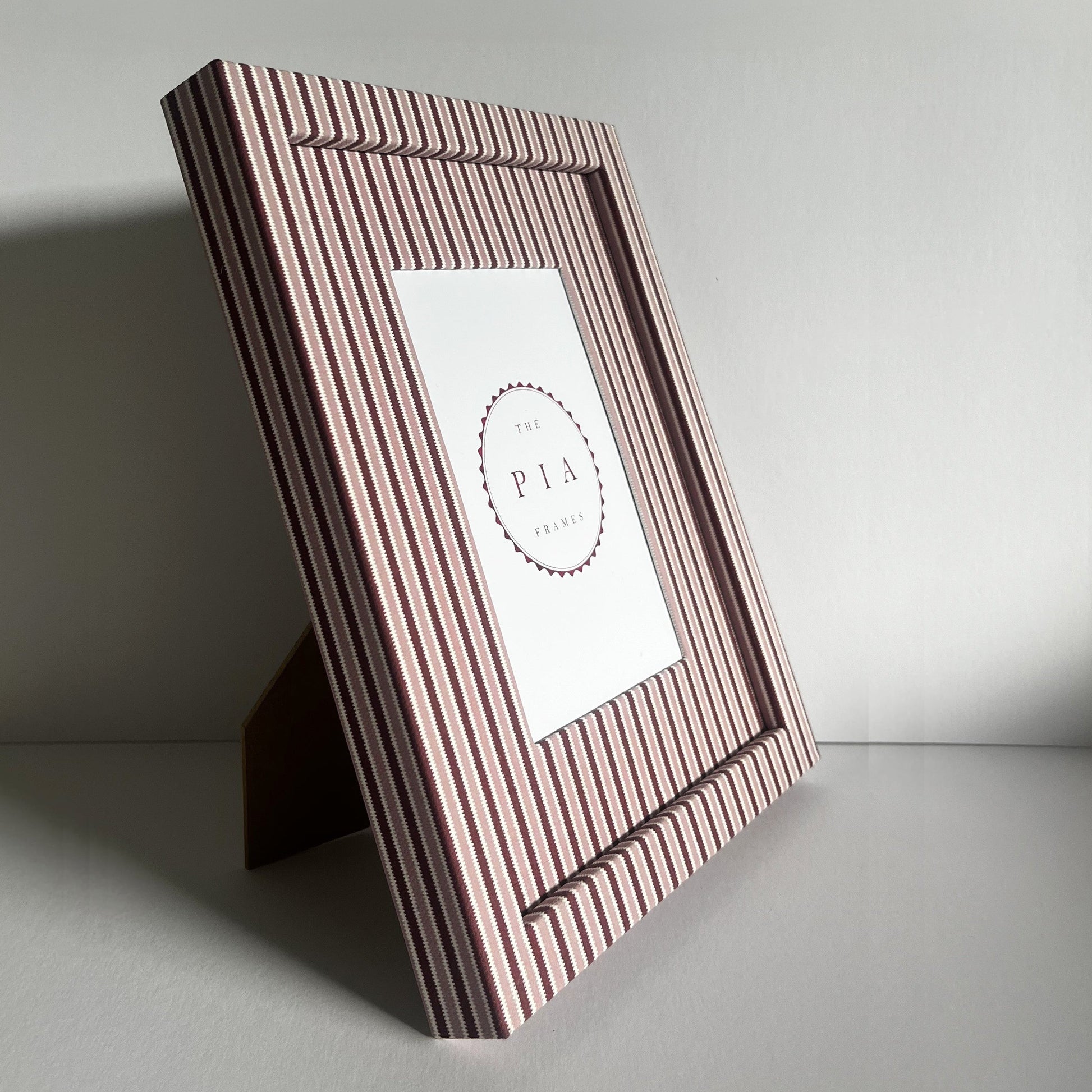 Handmade standing blush and burgundy zigzag picture frame on plain background