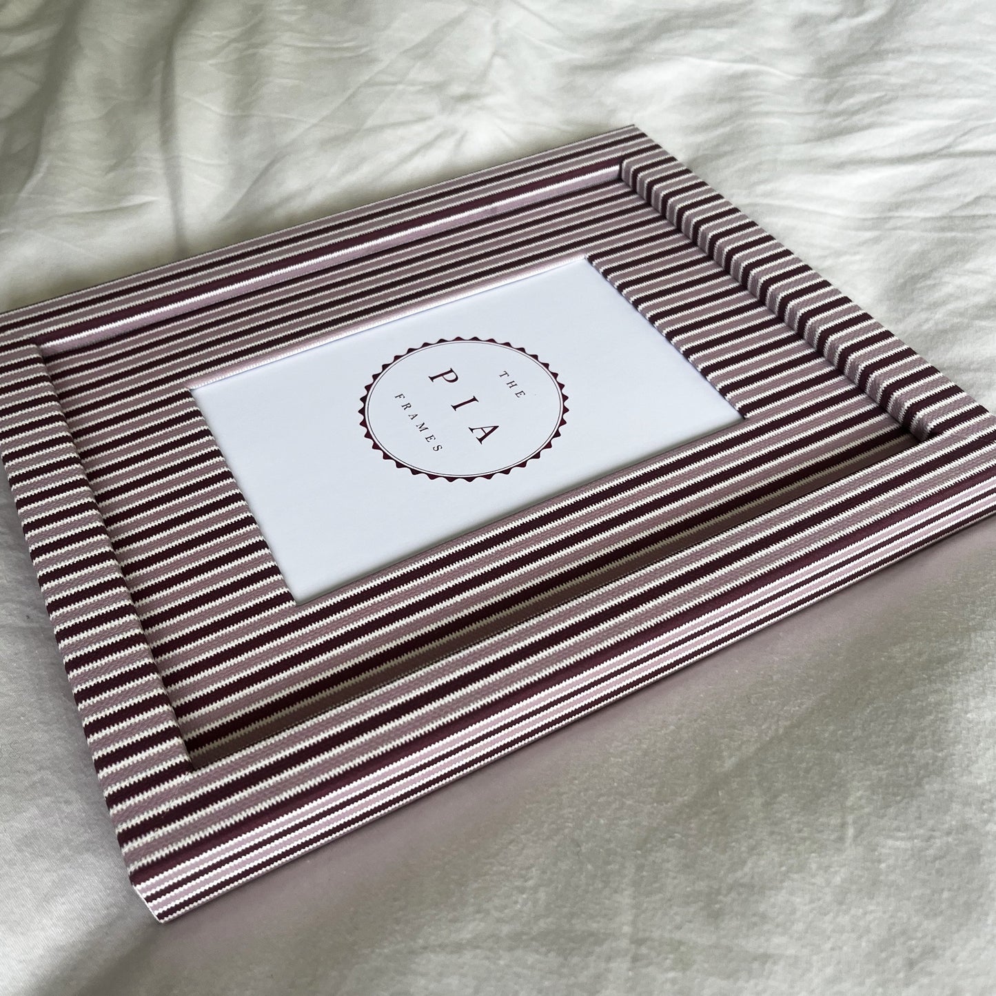 Handmade blush and burgundy zigzag picture frame angled full view on plain background
