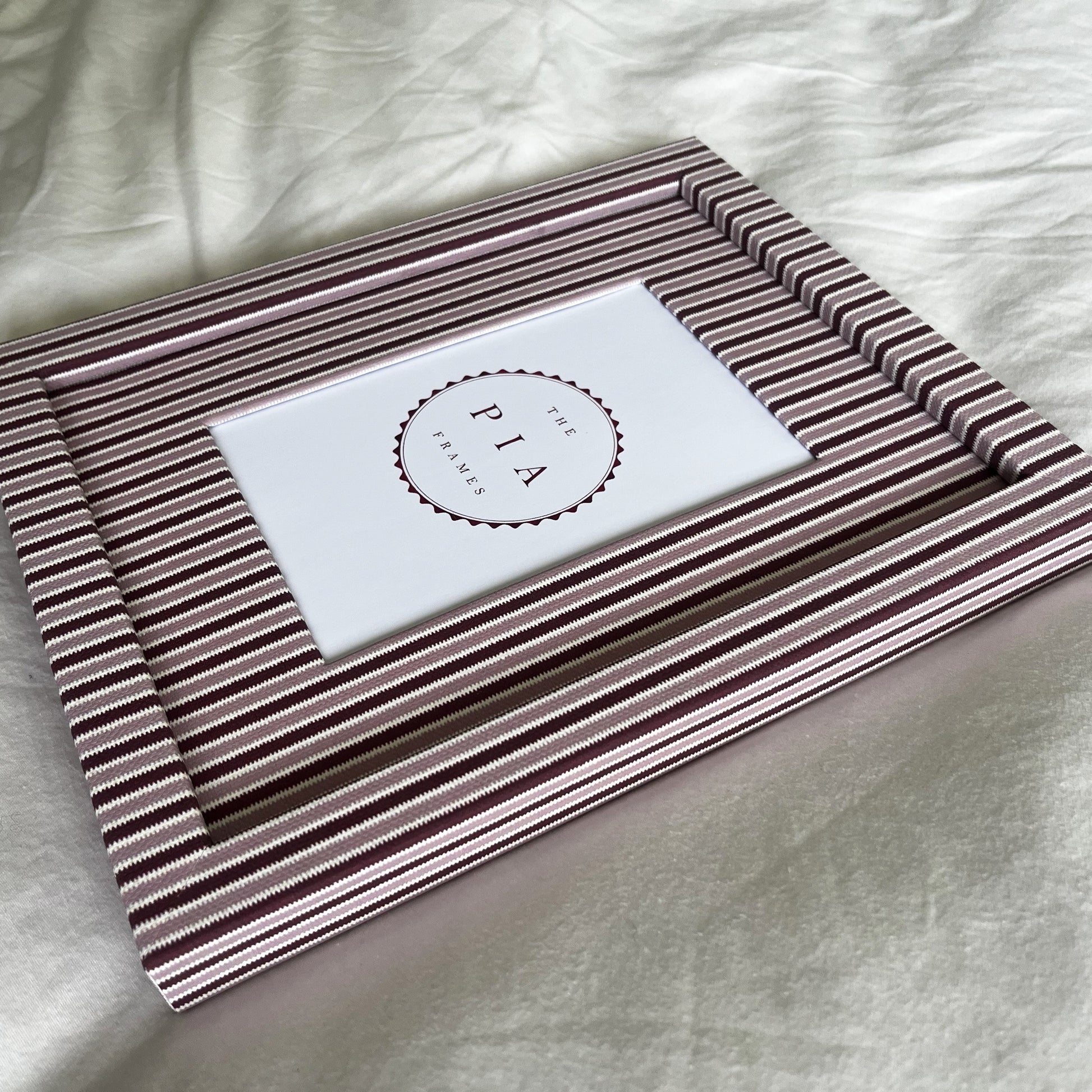 Handmade blush and burgundy zigzag picture frame angled full view on plain background