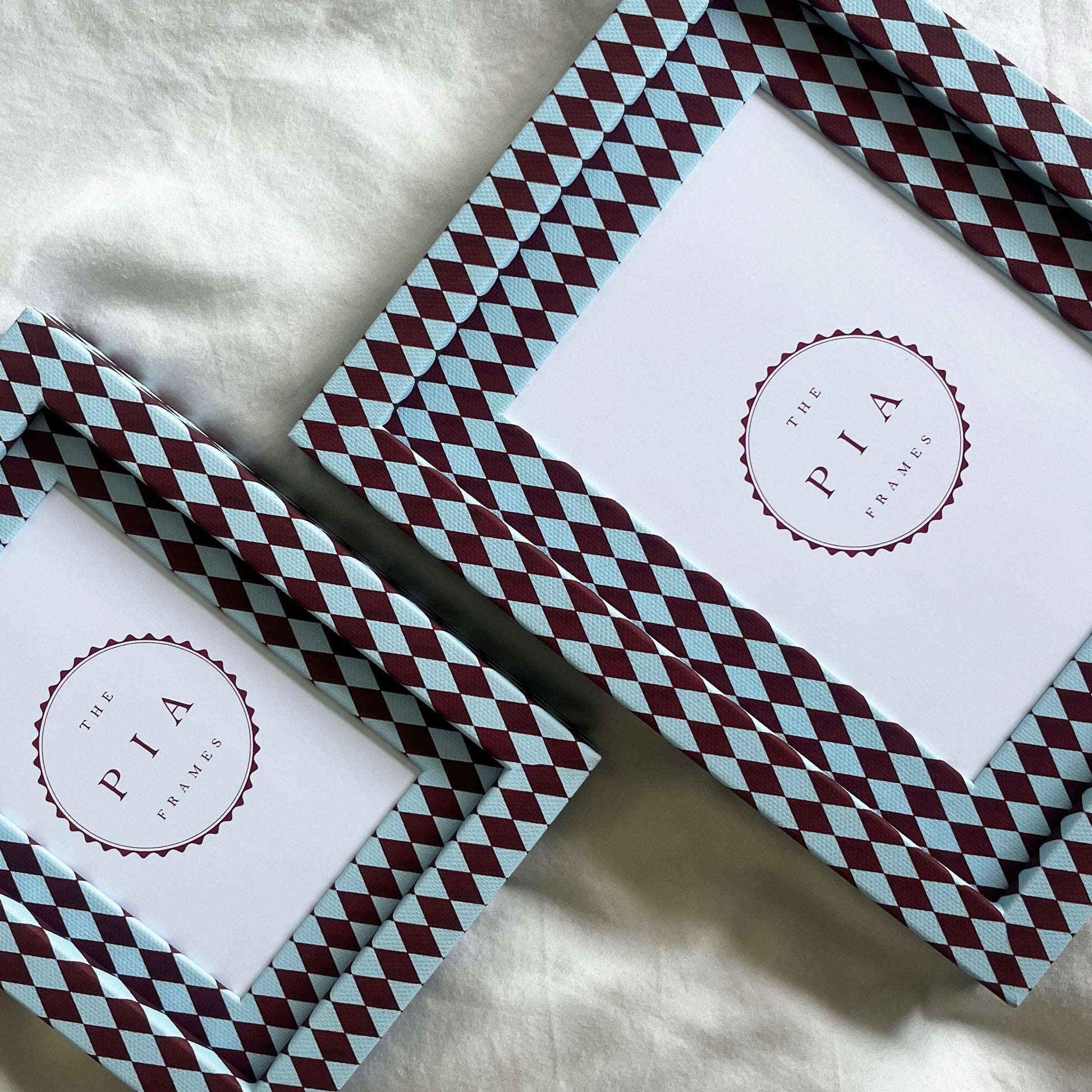 two burgundy and blue harlequin photo frames, showcasing different sizes