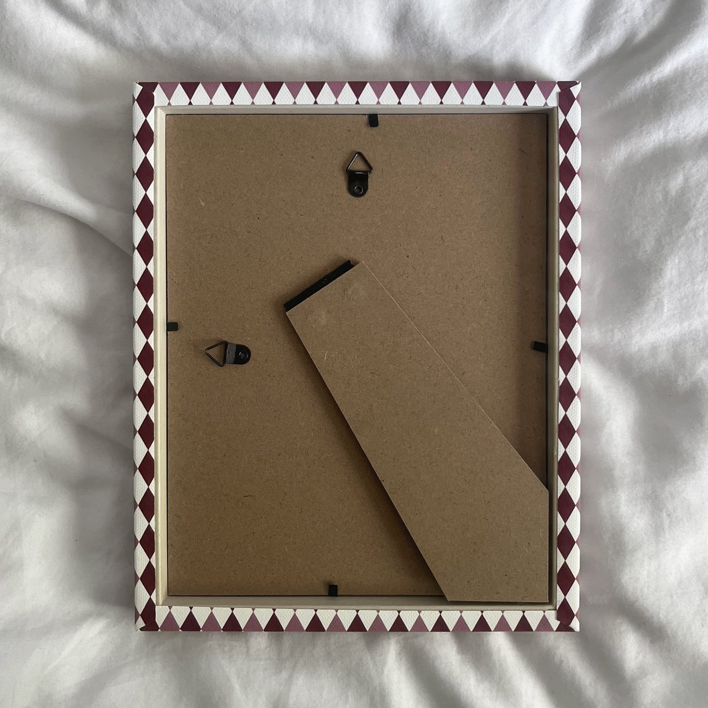 back view of a handmade geometric fabric photo frame showcasing wall fittings and frame structure