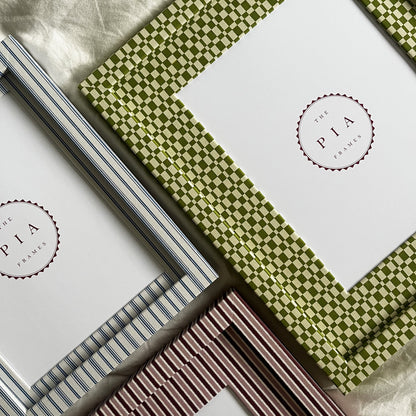 Set of three handmade colourful fabric picture frames on a white fabric background