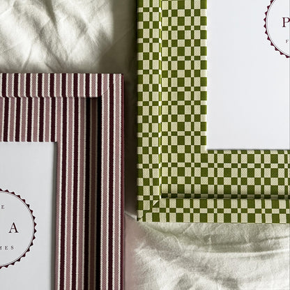 Set of two handmade fabric photo frames with striped and checkered designs on a white fabric background