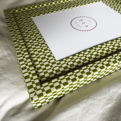 Angled side view of handmade green and beige checkered picture frame, showcasing its design and depth