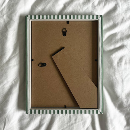 Back view of handmade green vanguard stripe picture frame, showing wall fittings and frame structure