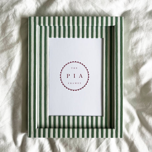 Full view of handmade green vanguard stripe picture frame on a neutral background