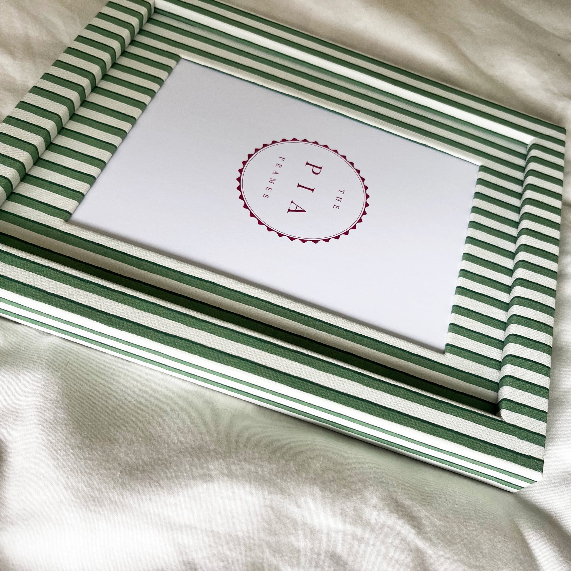 Side view of handmade green vanguard stripe picture frame, showcasing the frame’s depth and design