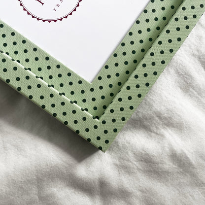 Close up view of handmade mint and jade Pembroke polka dot fabric picture frame, showing textural finish