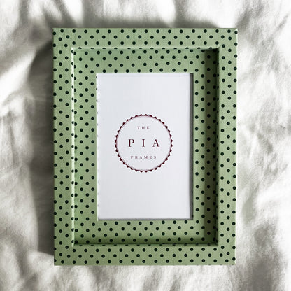 Full view of handmade mint and jade Pembroke polka dot picture frame on a neutral background