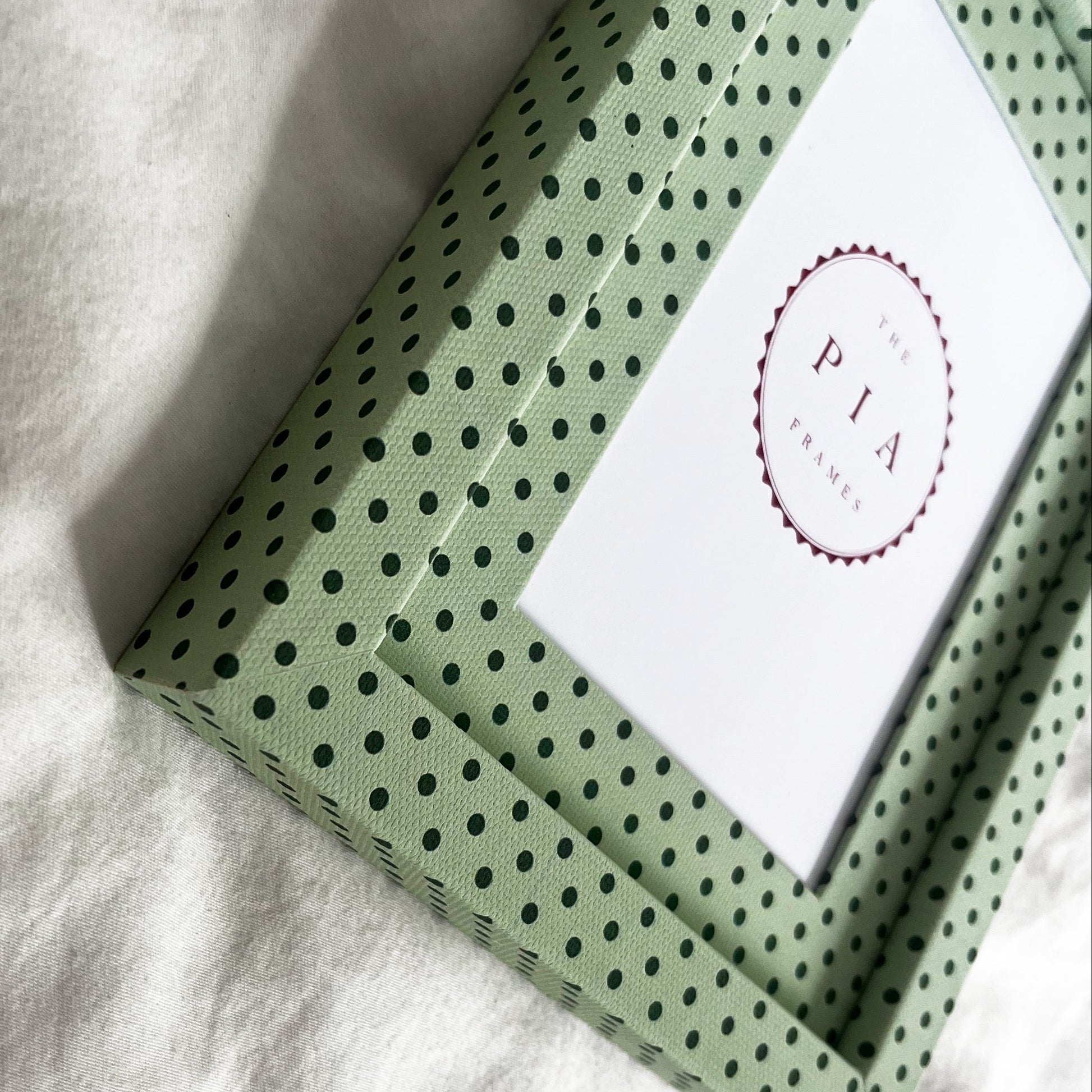 Side view of handmade mint and jade Pembroke polka dot fabric picture frame, showcasing its design and depth