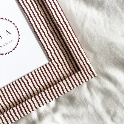 Close-up of terracotta and beige striped fabric picture frame
