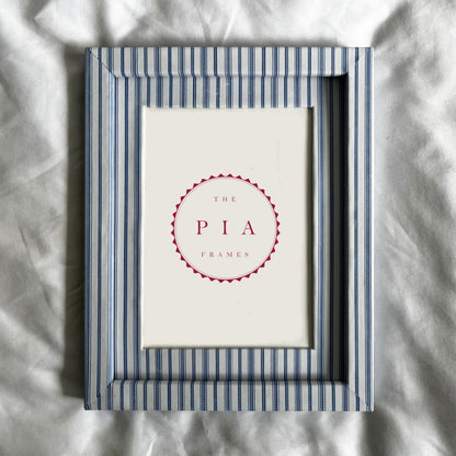 Framed picture with 'The Pia' logo on a textured white background