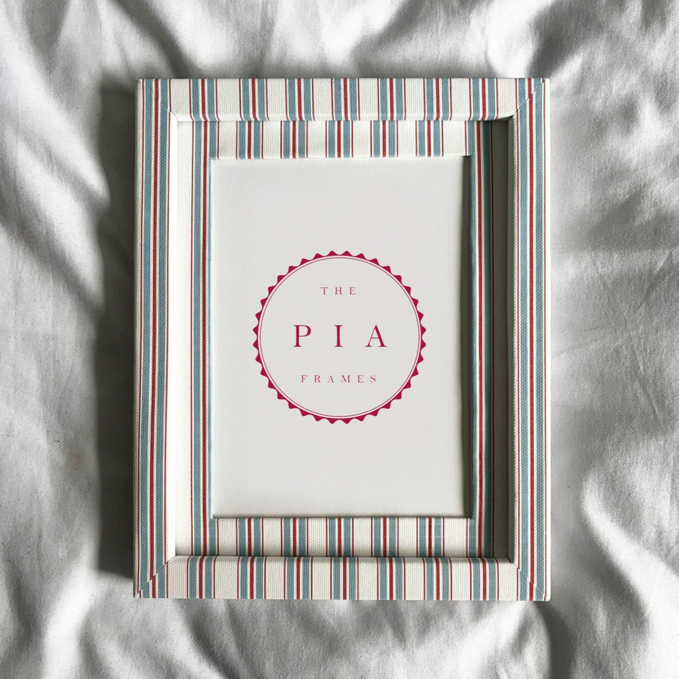 Striped picture frame on a white fabric background