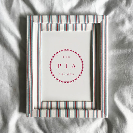 Striped picture frame on a white fabric background