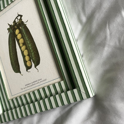 Side-angle view of Peas print in green striped frame, kitchen inspired vegetable print.