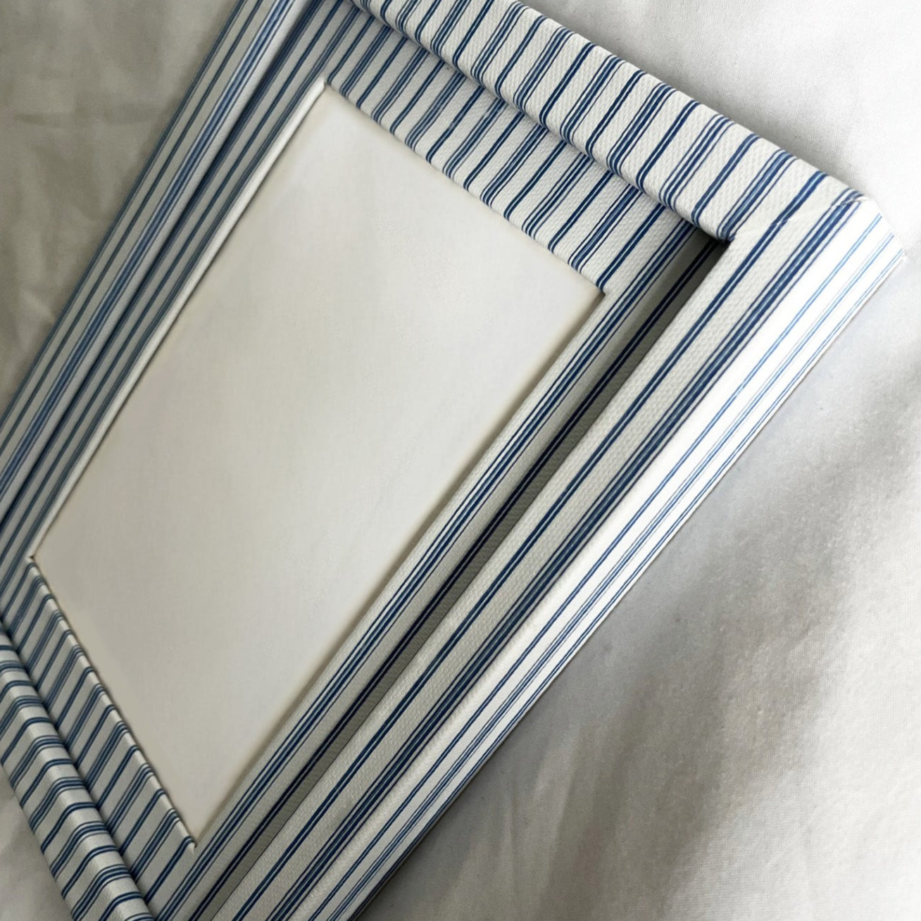 Striped picture frame on a white surface